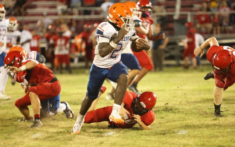 Branford running back Ollie James runs past a Dixie County defender Friday night during their Preseason Classic. (PAUL BUCHANAN/Lake City Reporter)