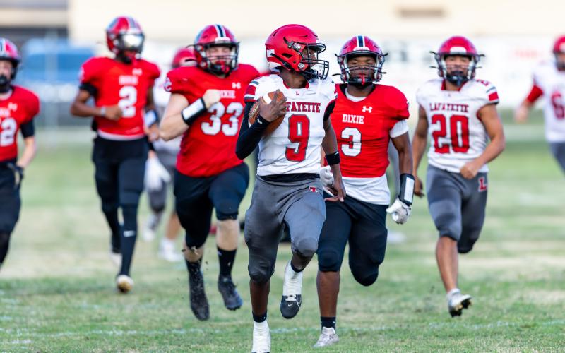 Lafayette quarterback Tywan Williamson (9) heads to the end zone for a touchdown Hornets’ first possession of the game during Friday’s win over Dixie County. (JACK HOWDESHELL/Lake City Reporter)