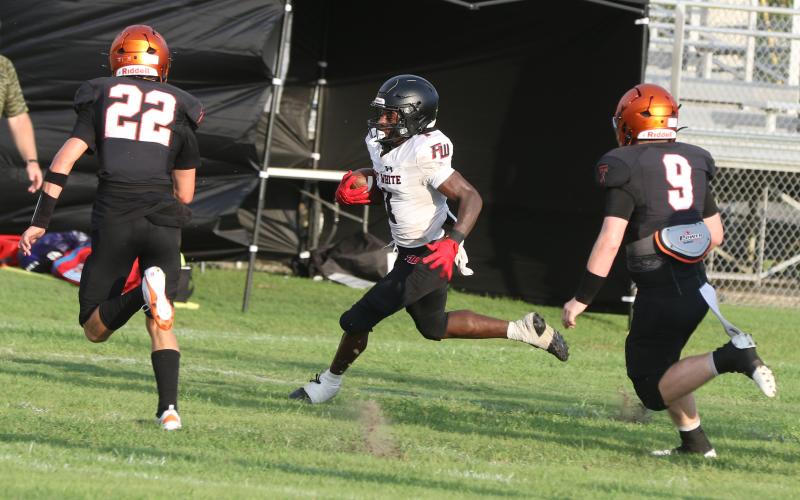 Fort White receiver John’l Lawson runs up field after a catch against Trenton during last week’s Preseason Classic. (MORGAN MCMULLEN/Lake City Reporter)