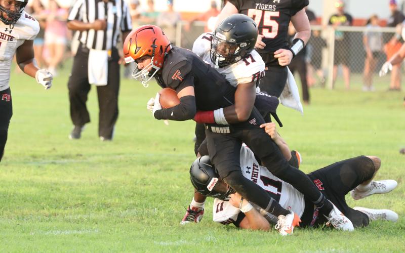 Fort White linebackers Cameron Lumpkin (17) and Teagin Bell (11) combine for a tackle on Trenton running back Brant Bivens during Friday’s Preseason Classic. (MORGAN MCMULLEN/Lake City Reporter)