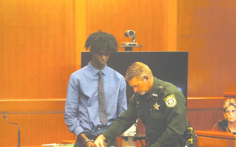 Jayden Burch is fingerprinted after being found guilty of murder and attempted murder on Wednesday in a 2023 shooting that killed 12-year-old Mariah Smith. (MORGAN MCMULLEN/Lake City Reporter)