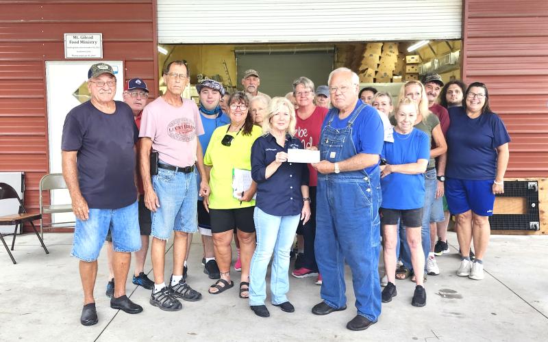 Members of Live Oak Elks Lodge #1165, Lori Watson (Lodge Grant Coordinator), Donald Watson (Past District Deputy) and Cathy Davis (Exalted Ruler) met at the Mt. Gilead Baptist Church Food Ministry in Falmouth on Saturday to present a $,6000 check from the Elks National Foundation Spotlight Grant to Gary Watson, food ministry founder/manager, and his team of volunteers. (COURTESY)