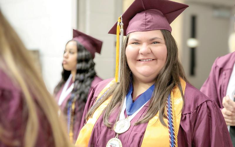 Standing among fellow expectant graduates at the NFC Spring 2025 Commencement Ceremony, Caroline Wynn smiles as she prepares to cross the stage and accept her diploma for an Associate in Arts Degree. (COURTESY)