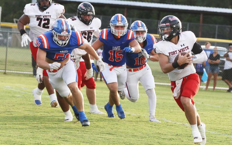 Fort White quarterback Matthew Pitts scrambles on the opening drive of Friday’s 20-3 loss at Taylor County. (MORGAN MCMULLEN/Lake City Reporter)