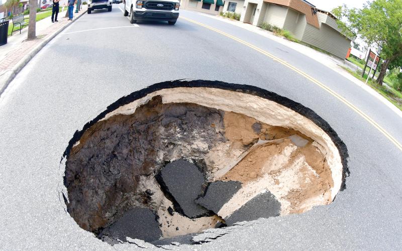 A sinkhole opened up Monday afternoon in the eastbound lane of E. Howard Street (U.S. Highwy 90) in downtown Live Oak near the intersection with Dowling Avenue. Florida Department of Transporation crews repaired the problem Monday night and the street has been reopened. (ROB WOLFE/Lake City Reporter)