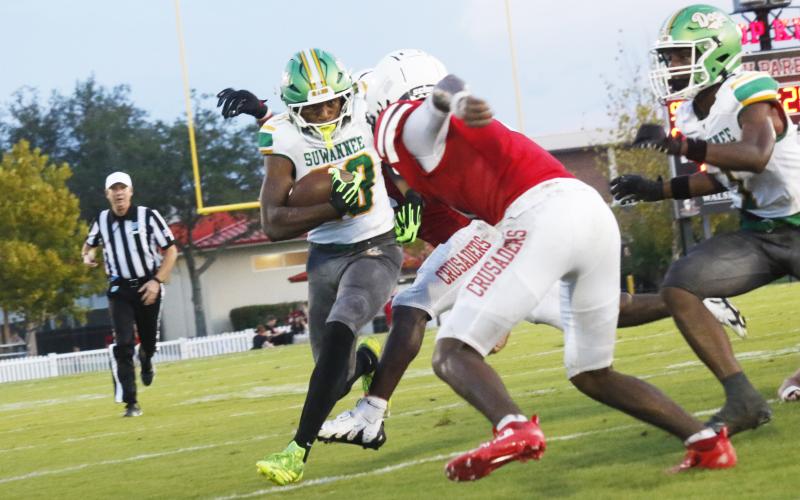 Suwannee running back Lou Jack Smith gets stuffed by a pair of Bishop Kenny defenders during Friday’s Preseason Classic. (JAMIE WACHTER/Lake City Reporter)