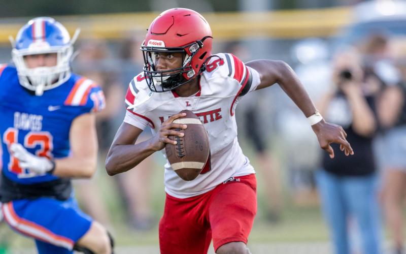 Lafayette quarterback Tywan Williamson scrambles against Taylor County during the Preseason Classic on Aug. 15. (Photos by JACK HOWDESHELL/Lake City Reporter)