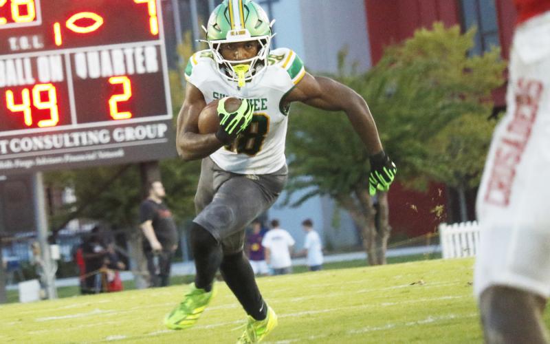 Suwannee running back Lou Jack Smith eyes a hole against Bishop Kenny in the Preseason Classic on Aug. 15. (JAMIE WACHTER/Lake City Reporter)