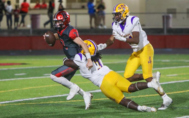 Columbia defensive lineman Terry Henry takes down Hillsborough quarterback Ethan Hanson for one of his three sacks on Friday. (BRENT KUYKENDALL/Lake City Reporter)