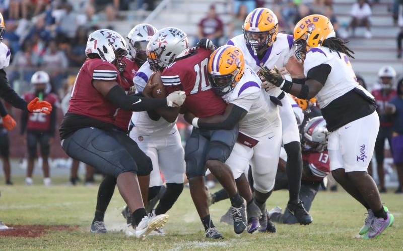 Columbia defensive tackle Jaden McCray tackles Madison County quarterback Chad Mitchell on Friday. (BRENT KUYKENDALL/Lake City Reporter)