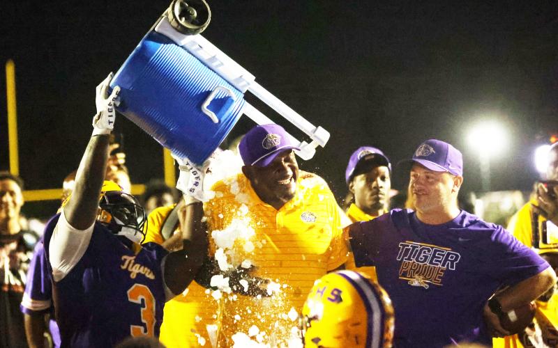 Columbia defensive lineman Terry Henry douses head coach Brian Allen with water after Allen recorded his 100th win. (PAUL BUCHANAN/Lake City Reporter)