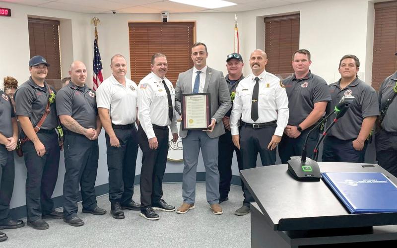 Members of the Lake City Fire Department, including Chief Josh Wehinger and Assistant Chief Rhet Tompkins, receive a proclamation from Mayor Noah Walker at Monday’s Lake City Council meeting for Firefighter Appreciation Month. (COURTESY CITY OF LAKE CITY)
