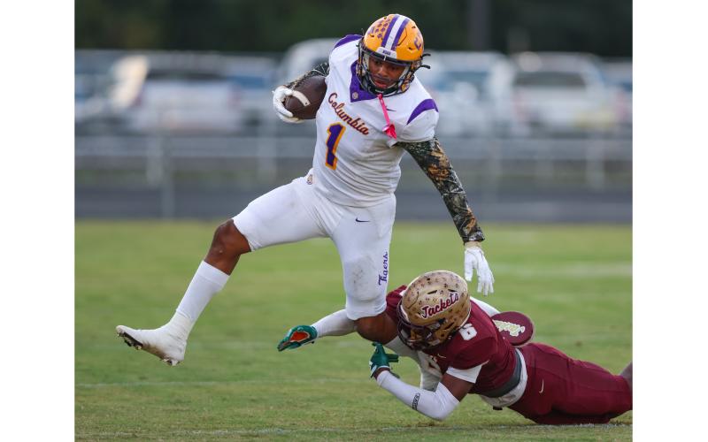 Columbia linebacker Kameron Mills gets tripped up by St. Augustine’s Marquell Elmore on a kickoff return Friday night. (GARY LLOYD MCCULLOUGH/Special to the Reporter)