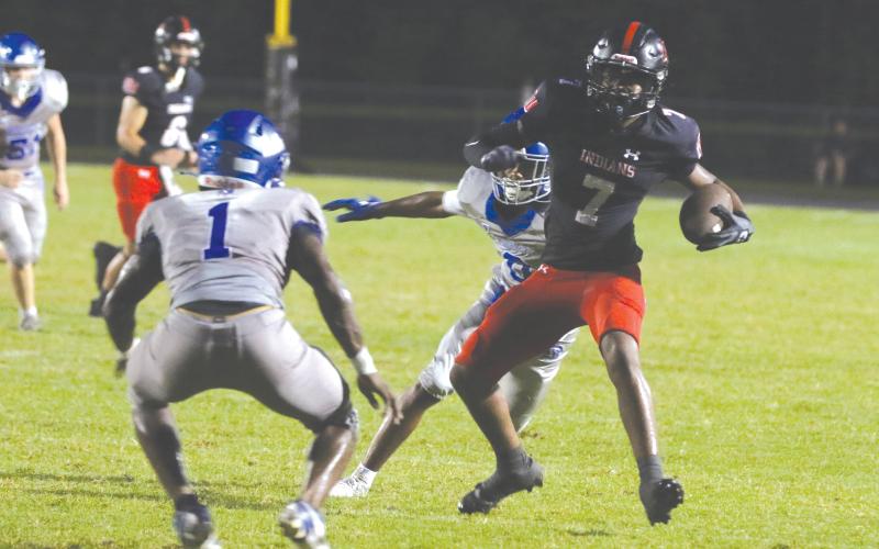 Fort White receiver X’Zaevion Gibson looks to make a play after a catch against Belleview last Friday. (MORGAN MCMULLEN/Lake City Reporter)