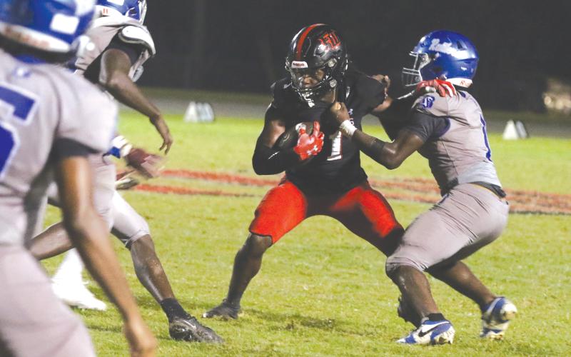 Fort White running back John’l Lawson tries to break away from a tackle Friday against Belleview. (MORGAN MCMULLEN/Lake City Reporter)