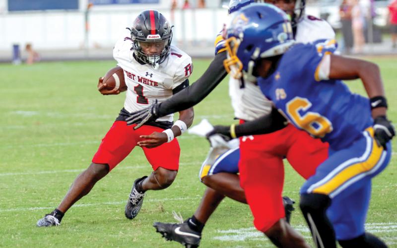 Fort White running back John’l Lawson looks for room to run Friday night against Fernandina Beach. (ASHLEY CHANDLER/Fernandina Beach News-Leader)