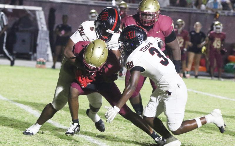 Fort White linebackers Darion Brinson (5) and Elijah Gardner (3) make a tackle against North Marion last Friday. (MORGAN MCMULLEN/Lake City Reporter)