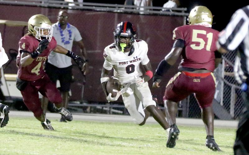 Fort White receiver Jayden Jackson looks for a lane on a sweep play Friday against North Marion. (MORGAN MCMULLEN/Lake City Reporter)