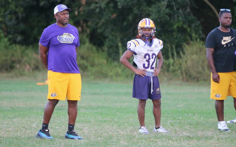 Drew Simmons (32) watches practice alongside Columbia coach Brian Allen (left) on Tuesday. (JORDAN KROEGER/Lake City Reporter)