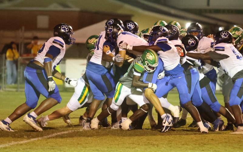 Godby quarterback Landon Dougherty reaches for the end zone as teammates push behind him Friday night at Langford Stadium. Suwannee’s Jayden Polite tries to hold him up. (PAUL BUCHANAN/Lake City Reporter)