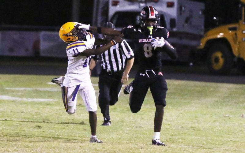 Fort White’s Jayden Jackson stiff-arms Union County defensive back Natwan Richardson during a punt return in Friday’s 47-0 win. (MORGAN MCMULLEN/Lake City Reporter)