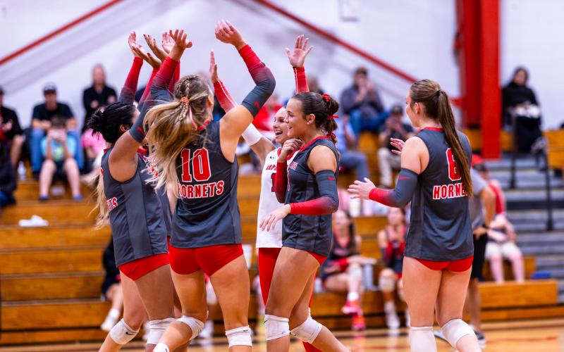 Lafayette's volleyball team celebrates after scoring a point against Columbia on Monday. (JACK HOWDESHELL/Lake City Reporter)