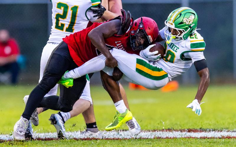 Lafayette defensive lineman Zamarion Hawkins tackles Suwannee running back Lou Jack Smith on Friday. (JACK HOWDESHELL/Lake City Reporter)