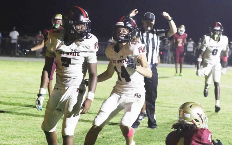 Fort White receiver Ashton Giddens (right) runs to celebrate with fellow receiver X’Zaevion Gibson after Gibson’s go-ahead 31-yard touchdown catch in Friday’s 41-40 win over North Marion. (MORGAN MCMULLEN/Lake City Reporter)