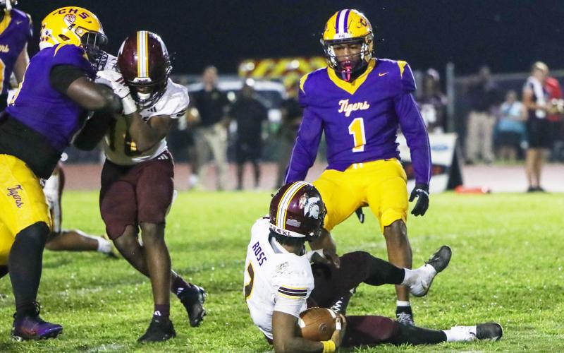 Columbia linebacker Kameron Mills stares down Coffee quarterback Trey Ross after tackling him on Friday. (BRENT KUYKENDALL/Lake City Reporter)