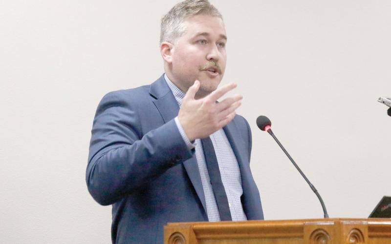 Matthew Ori, a senior consultant with Raftelis, talks to the North Florida Water Utilities Authority board on Wednesday about the status of the rate study being performed by the group. (JAMIE WACHTER/Lake City Reporter)