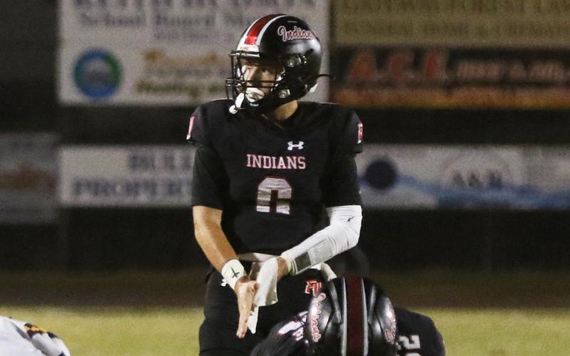 Fort White quarterback Matthew Pitts lines up for a snap during Friday’s win over Union County. (MORGAN MCMULLEN/Lake City Reporter)