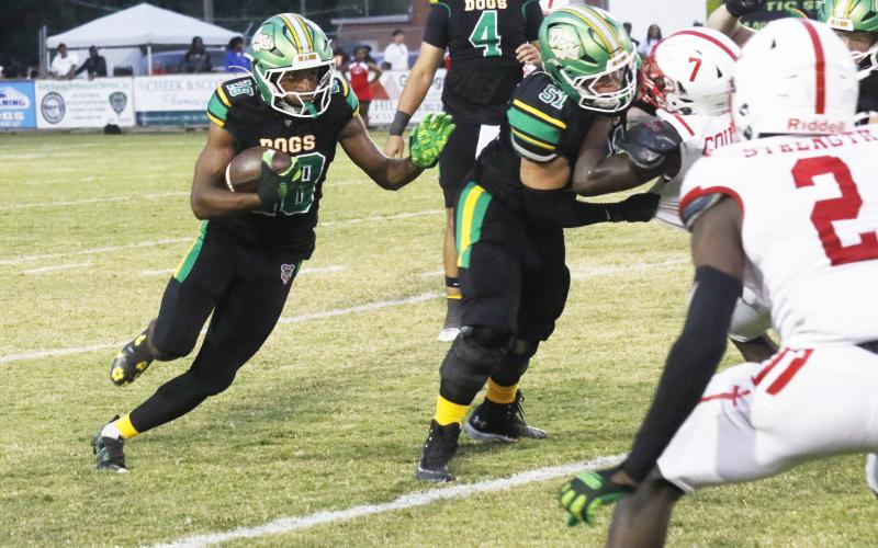 Suwannee running back Lou Jack Smith eyes a hole behind a block from guard Brody Bean against Hamilton County last Friday. (JAMIE WACHTER/Lake City Reporter)