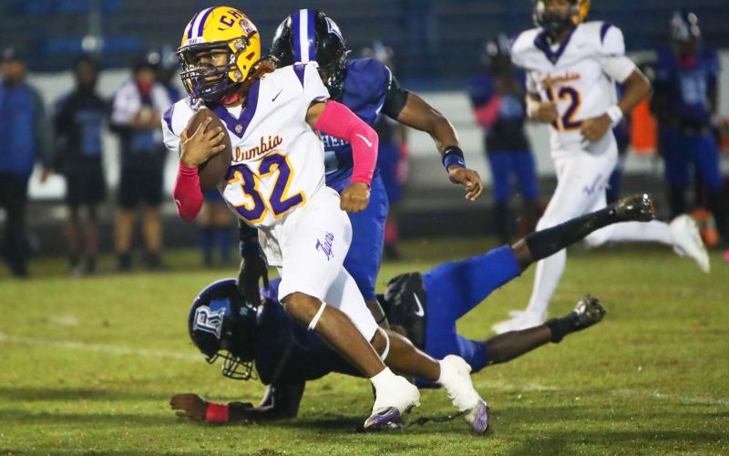 Columbia running back Drew Simmons races past a Ridgeview defender on one of his touchdowns Friday. (BRENT KUYKENDALL/Lake City Reporter)