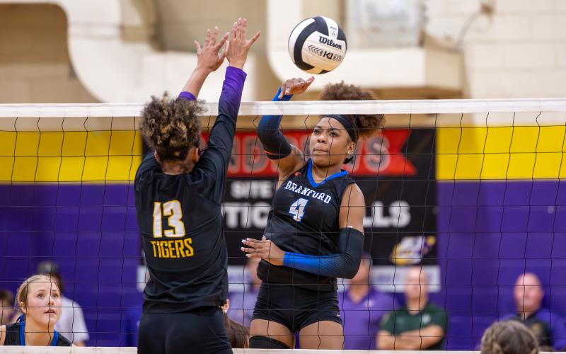 Branford hitter Adriauna Combs (4) and Union County hitter Jailyn Simmons (13) battle at the net during the District 6-R championship on Thursday. (JACK HOWDESHELL/Lake City Reporter)