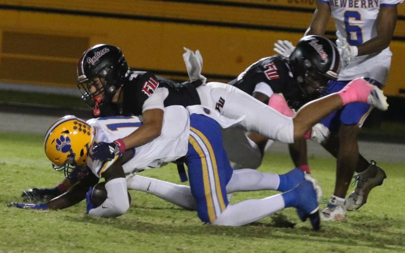 Fort White defensive back Ja’vion Bailem makes a tackle against Newberry on Oct. 17. (MORGAN MCMULLEN/Lake City Reporter)