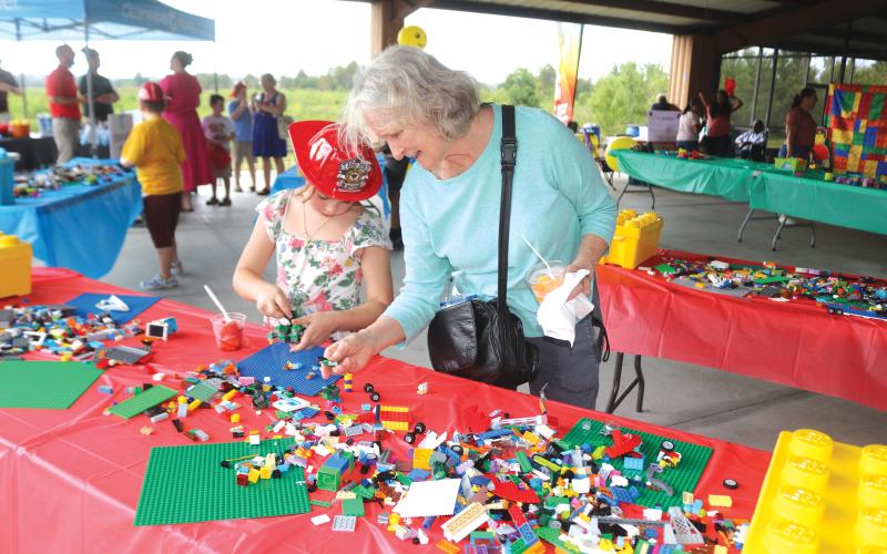 Denise Barth (right) works with 7-year-old Rowan Barth during Monday’s event. (TONY BRITT/Lake City Reporter)