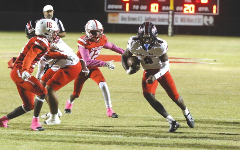 Fort White quarterback Jayden Jackson runs through the middle of Hamilton County’s defense on Friday. (MORGAN MCMULLEN/Lake City Reporter)