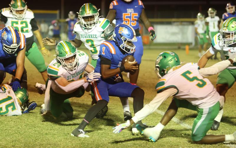 Suwannee defensive end Kyler Watson dives to try and tackle Taylor County quarterback Jabez Glanton as he runs through the Bulldogs’ defense on Friday. (PAUL BUCHANAN/Lake City Reporter)