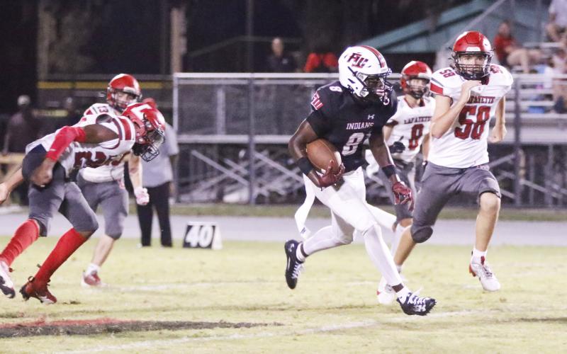 Fort White receiver Jayden Jackson returns a punt for a touchdown against Lafayette last season. (FILE)