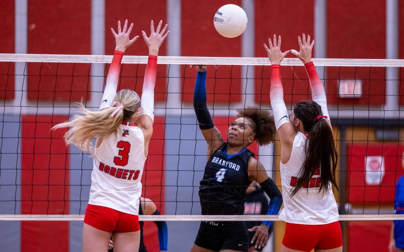 Branford hitter Adriauna Combs delivers a shot past Lafayette's Copelyn Johnson and Maci Wimberley (4) on Oct. 9. (JACK HOWDESHELL/Lake City Reporter).