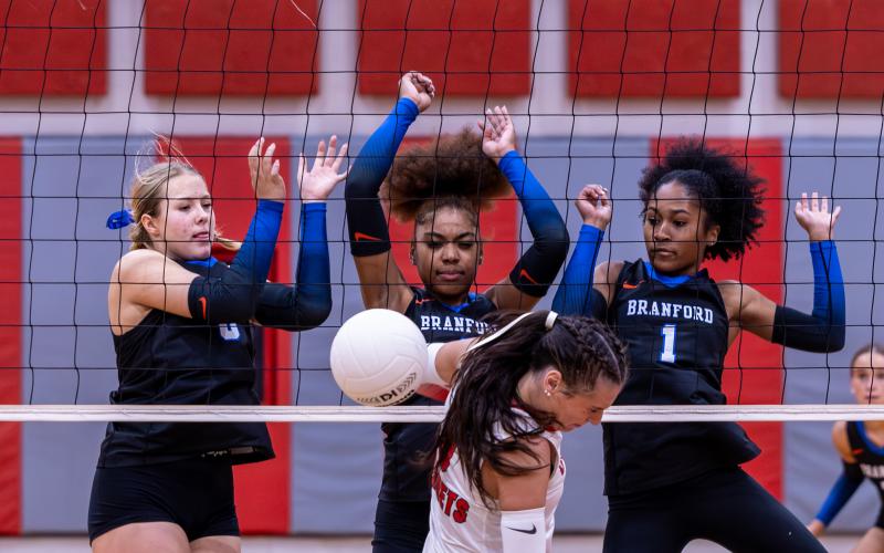 Branford's Anabella Dicks (8), Adriauna Combs (4) and Kaleah Tucker (1) block the attack of Lafayette's Sophia Kendrick on Thursday night. (JACK HOWDESHELL/Lake City Reporter)