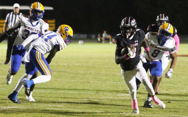 Fort White’s Jayden Jackson races for a 16-yard touchdown run against Newberry on Friday. (MORGAN MCMULLEN/Lake City Reporter)