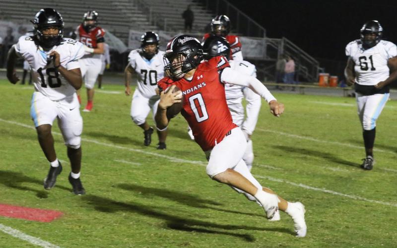 Fort White running back Ezekiel Powell sprints around the Zarephath Academy defense during last Friday’s 49-6 win. (MORGAN MCMULLEN/Lake City Reporter)