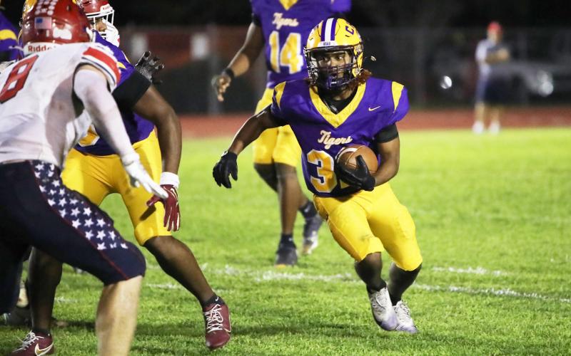 Columbia running back Drew Simmons looks for running room against Manatee last Friday. (BRENT KUYKENDALL/Lake City Reporter)