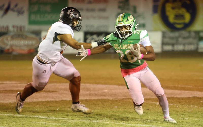 Suwannee running back Lou Jack Smith tries to escape a tackle from an Atlantic Coast defender last Friday. (PAUL BUCHANAN/Lake City Reporter)