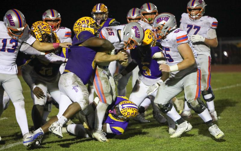 Bolles running back Xander Edwards carries Columbia defenders for extra yardage during his team’s 31-0 win on Friday. (BRENT KUYKENDALL/Lake City Reporter)