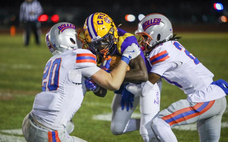 Columbia receiver Kyren Caldwell gets wrapped up by a pair of Bolles defenders following a catch on Friday. (BRENT KUYKENDALL/Lake City Reporter)