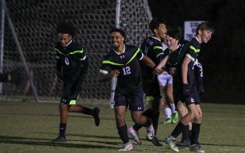 Columbia's Josiah Hopkins (12) celebrates with teammates after scoring a goal against Keystone Heights on Monday. (BRENT KUYKENDALL/Lake City Reporter)