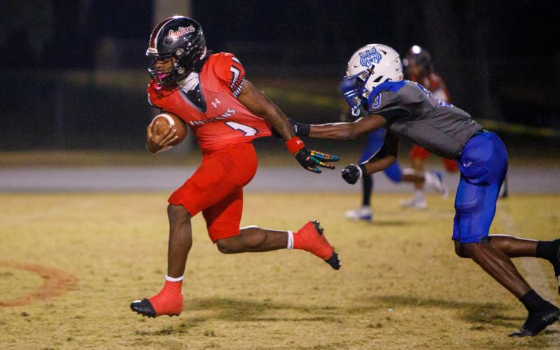 Fort White running back John'l Lawson breaks a tackle on his way to a touchdown against Wildwood during the FIT quarterfinals on Thursday. (BRENT KUYKENDALL/Lake City Reporter)