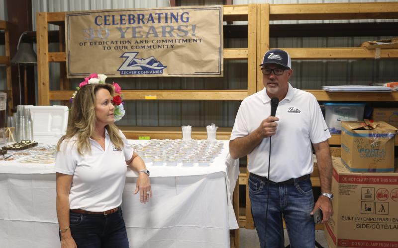 Bryan Zecher speaks at a celebration Tuesday of his company’s 30 years in business. Missy Zecher listens. (TONY BRITT/Lake City Reporter)